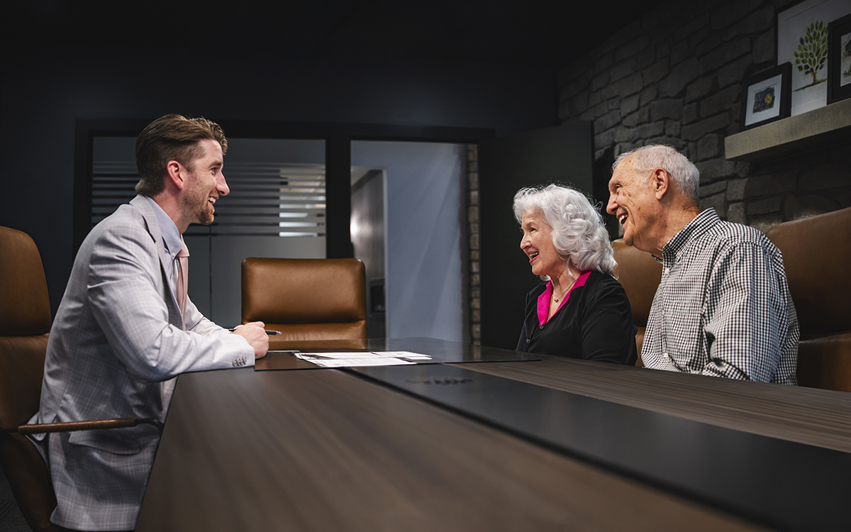 Howard Bailey advisor meeting with two clients at a table